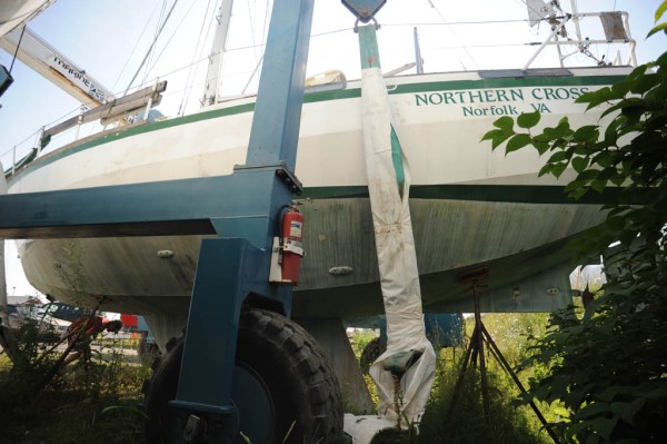 The travel lift prepares to move Northern Cross from the jungle that has grown around her.