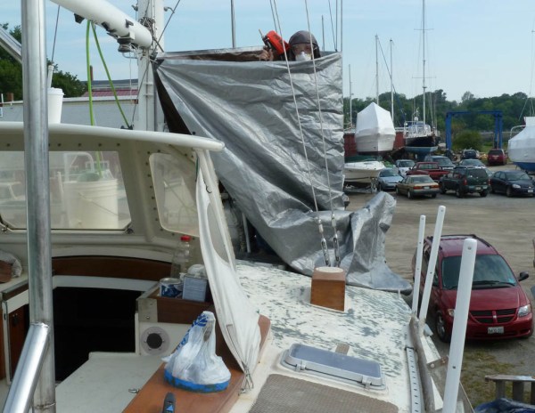 Enclosing an area with tarps and sandblasting around the chainplates.