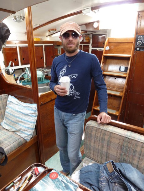 Coffee in hand and ready to remove those toe-rails from the after-deck. (Photo by Kate) Coffee in hand and ready to remove those toe-rails from the after-deck. (Photo by Kate)