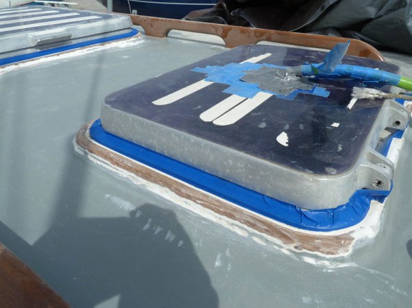 Preparing the wood hatch beds for epoxy.