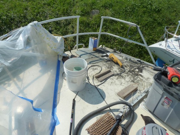 Starboard side details sandblasted and painted (drying under the plastic sheeting), time to start on the port side.