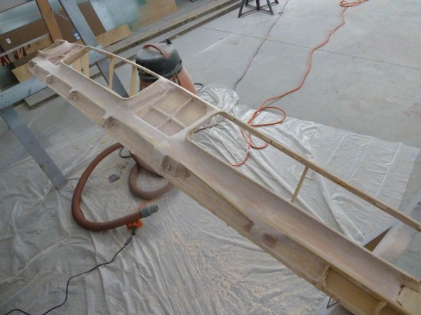 Starting to look better. Using bondo for filleting and additional balsa, a "box frame" of sorts is created that runs inside the entire curved length (over 9') of the panel.