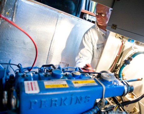 Dad making adjustments as the engine fires away.