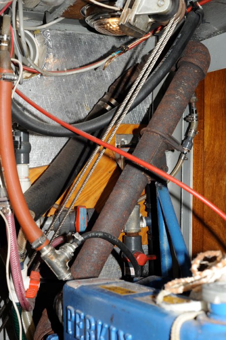 Fiberglass insulation removed to reveal a rusted but intact exhaust manifold. Add that to the winter projects list.