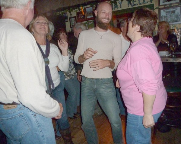 Dancing a jig with Taryn, Aunt Marge and Charles while Taryn laughs at my lack of coordination.