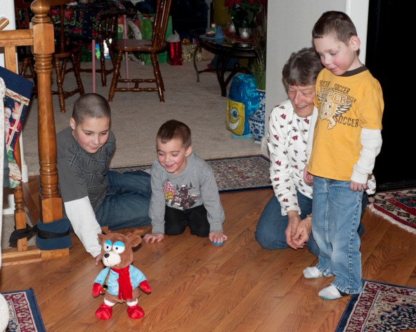 Gage, Jace, Mom, and Tayt watch the dancing Christmas Bear Reindeer Creature.
