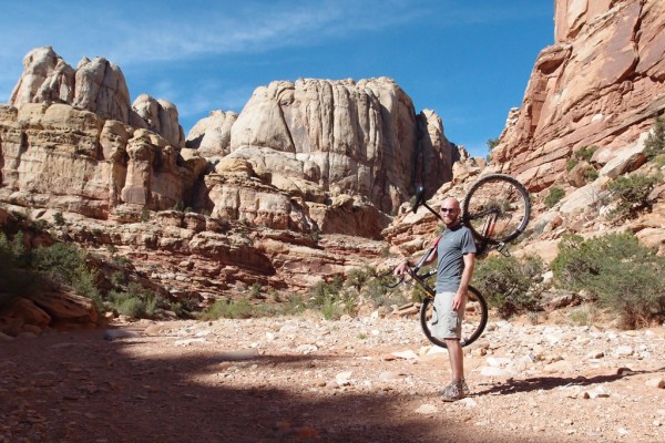Carrying the bike through a section of hiking-only trail in the Grand Wash.