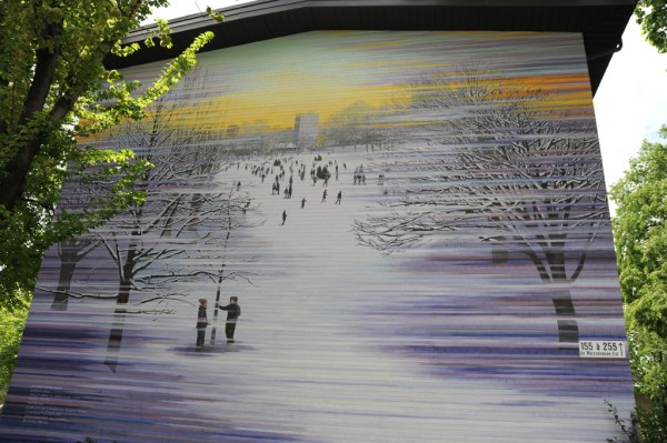 Painted brick on the side of an apartment building.