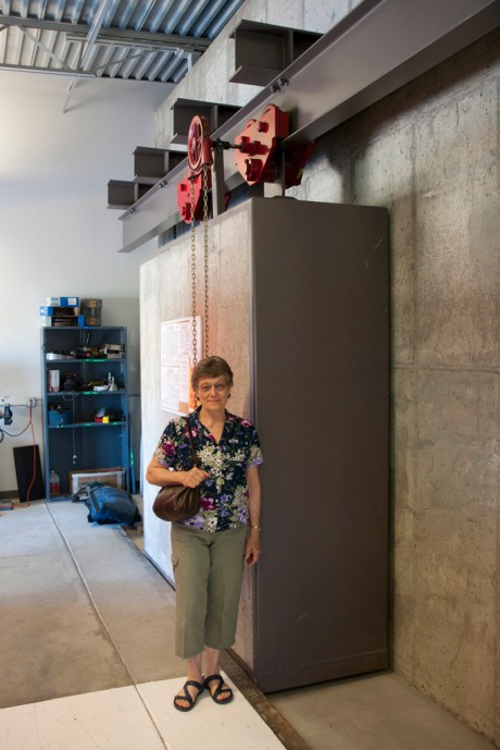 Mom stands next to a really big door used to shield the outer areas of the laboratory from radiation.