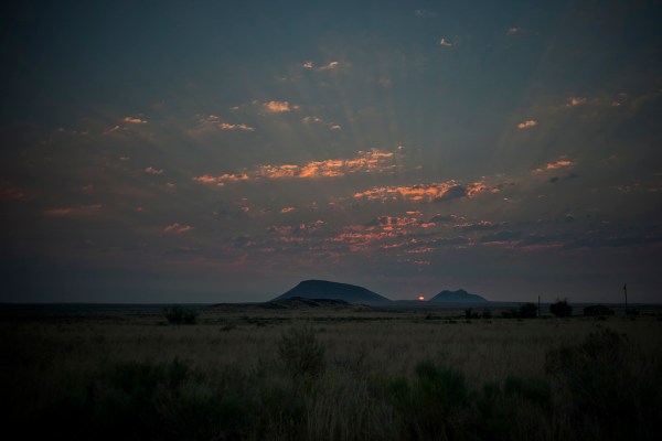The sun rises over a sea of sagebrush between the East and Middle Buttes.