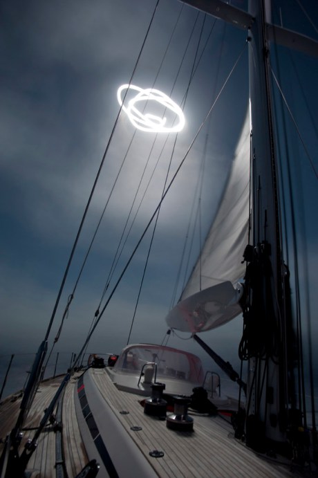 Sailing in rolling seas under a full moon.