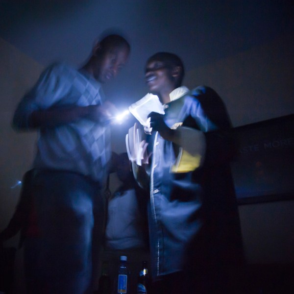 Paying the bill at one of the wedding planning meetings, held at Bustani's during a power outage.