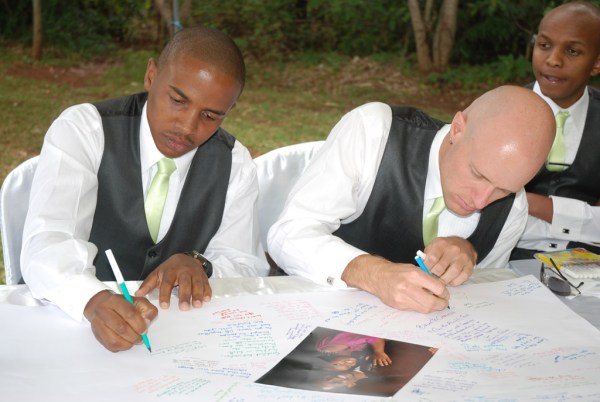 Gachanja and I sign the bridal poster. - Photo by JoeLink Media