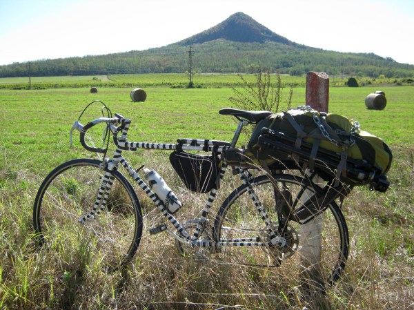 Punda Milia poses in front of Gulács Montain as we ride south from Tapolca.