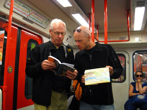 Dad and I reading the chapter titled "How Not to Look Like Tourists" while riding the metro.